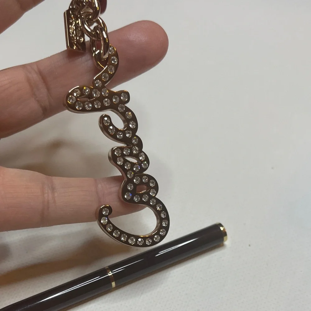Coach Gold Rhinestone Keychain with a Black Coach Pen